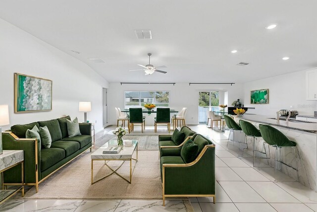 living room featuring a ceiling fan, visible vents, and recessed lighting