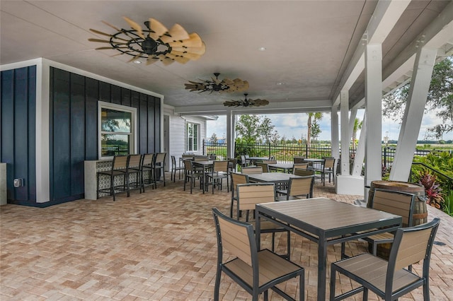 view of patio / terrace with outdoor dining area, ceiling fan, and fence