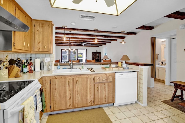 kitchen with beam ceiling, sink, hanging light fixtures, range hood, and white appliances