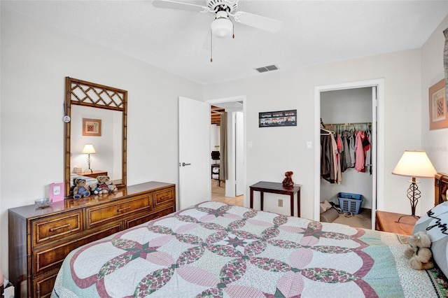 bedroom featuring ceiling fan, a walk in closet, and a closet