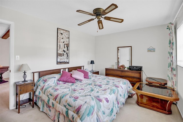 bedroom featuring light colored carpet and ceiling fan