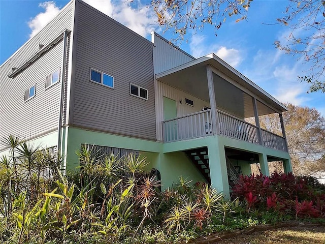 back of property featuring a balcony