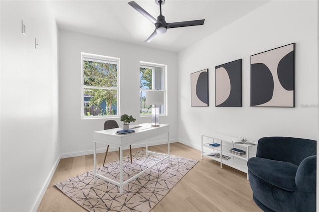 home office featuring light wood-type flooring and ceiling fan