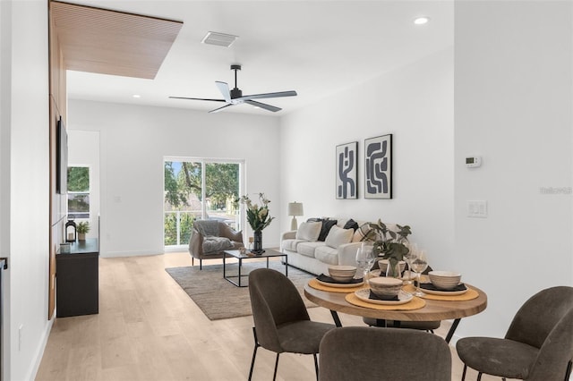 living room with ceiling fan and light hardwood / wood-style flooring