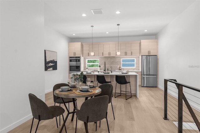 dining space with light hardwood / wood-style flooring