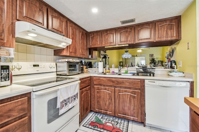 kitchen with a textured ceiling, white appliances, ceiling fan, sink, and light tile patterned floors