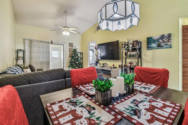 living room featuring ceiling fan and lofted ceiling