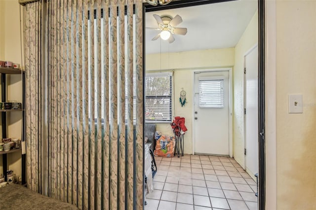 tiled entryway with ceiling fan