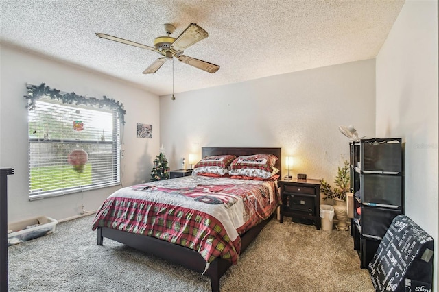 carpeted bedroom featuring ceiling fan and a textured ceiling