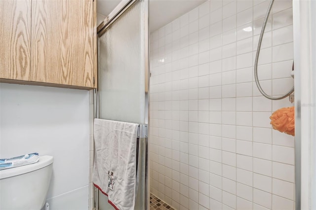 bathroom featuring toilet and walk in shower