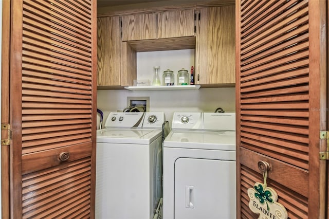 laundry area with cabinets and separate washer and dryer