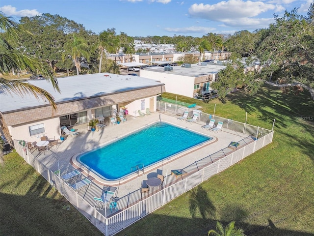 view of pool with a patio area and a yard