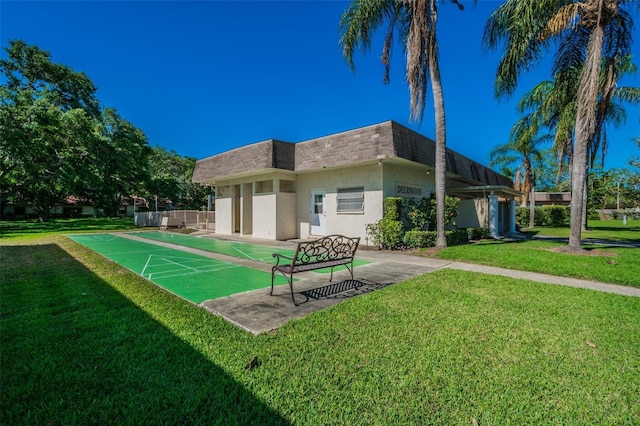 rear view of house featuring a lawn