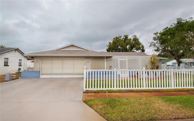 ranch-style house featuring a garage and a front yard