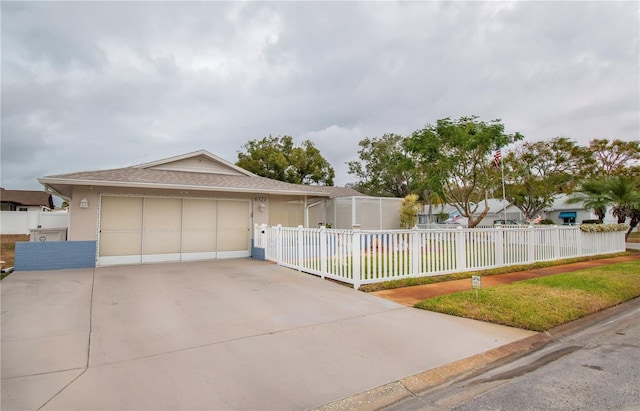 view of front of property with a garage and a front lawn