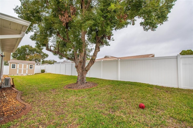 view of yard featuring cooling unit and a storage shed