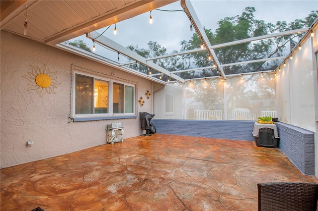 view of patio featuring a lanai