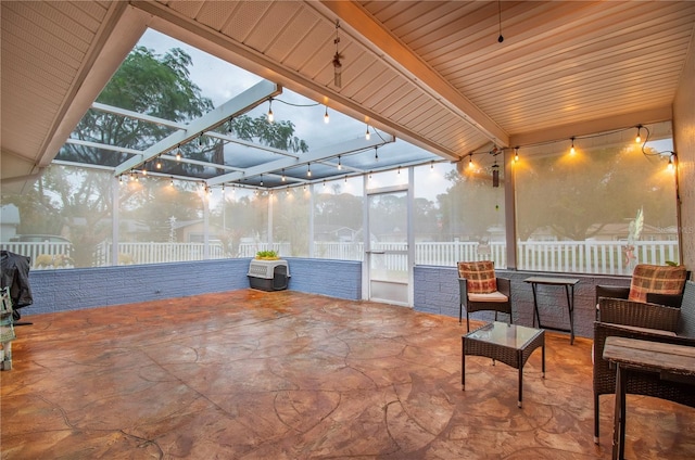 patio terrace at dusk featuring glass enclosure