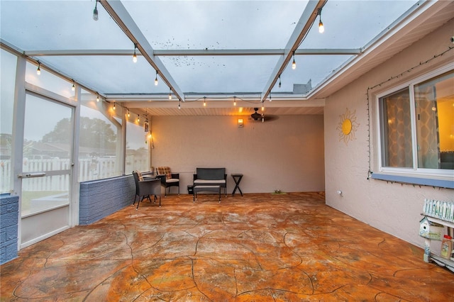 sunroom with rail lighting and a skylight