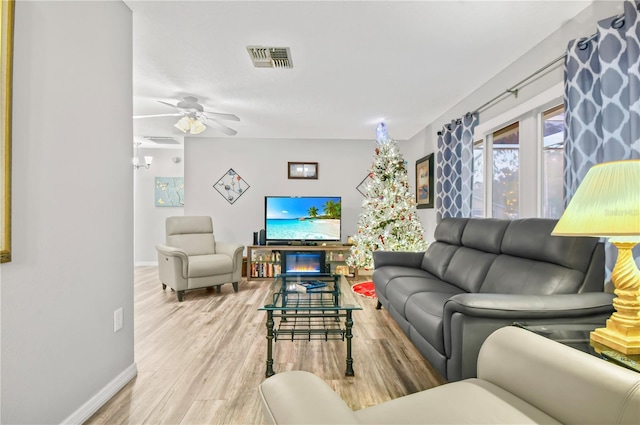 living room featuring ceiling fan and wood-type flooring