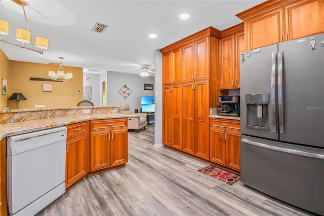 kitchen featuring white dishwasher, ceiling fan with notable chandelier, stainless steel refrigerator with ice dispenser, light wood-type flooring, and decorative light fixtures