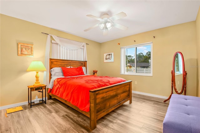 bedroom with ceiling fan and light hardwood / wood-style floors