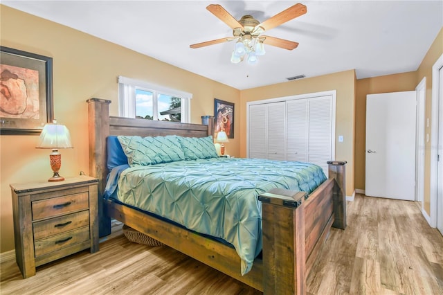 bedroom featuring ceiling fan, light wood-type flooring, and a closet