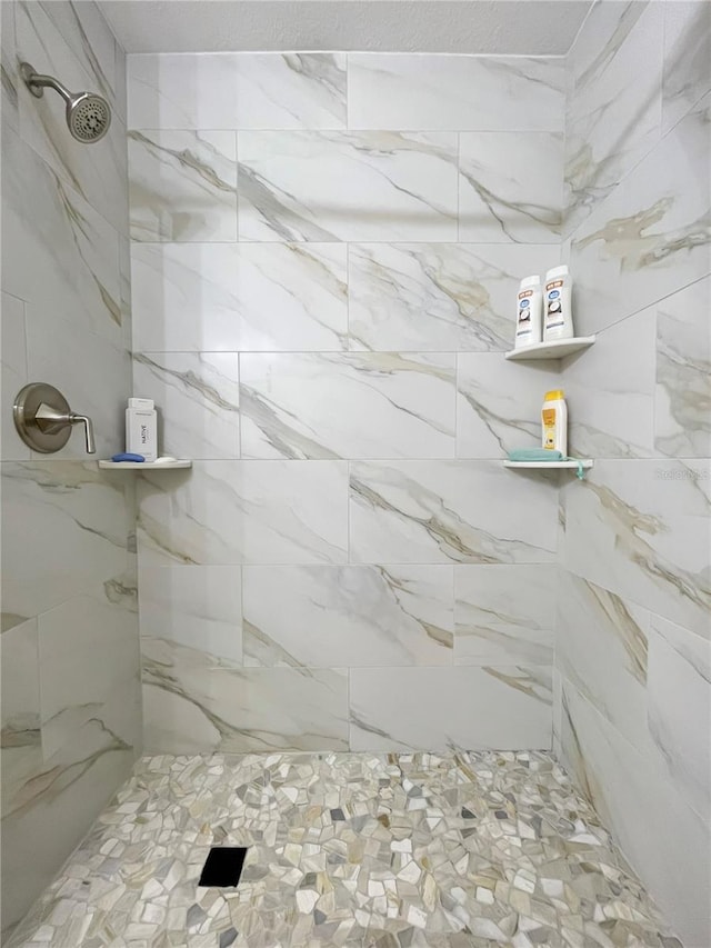 bathroom with a tile shower