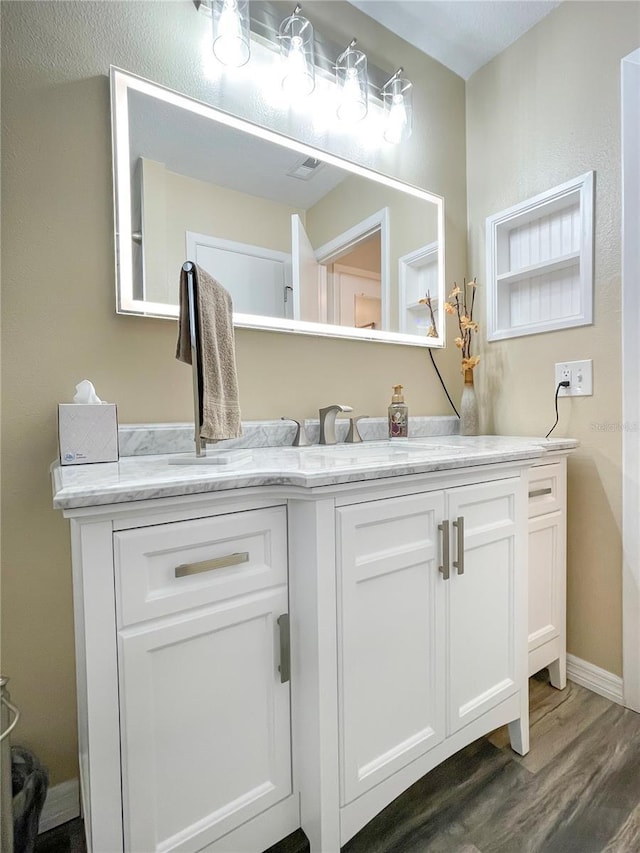 bathroom with hardwood / wood-style flooring and vanity