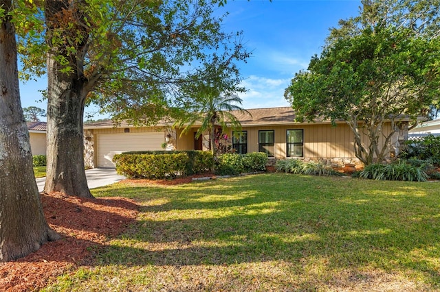 single story home featuring a front lawn and a garage