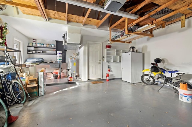 garage featuring white refrigerator and water heater