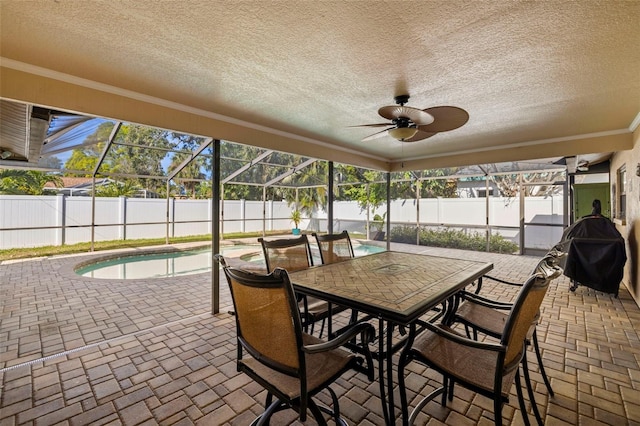 sunroom featuring plenty of natural light, ceiling fan, and a swimming pool