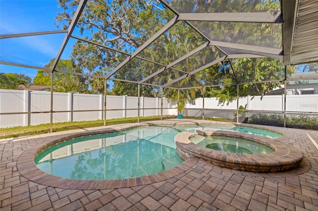 view of swimming pool with a patio area, a lanai, and an in ground hot tub