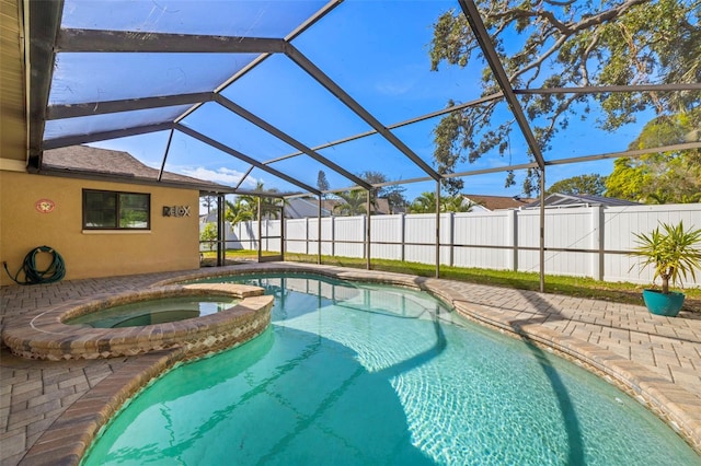 view of pool featuring an in ground hot tub and glass enclosure