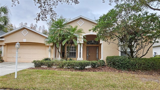 view of front of home with a front yard and a garage