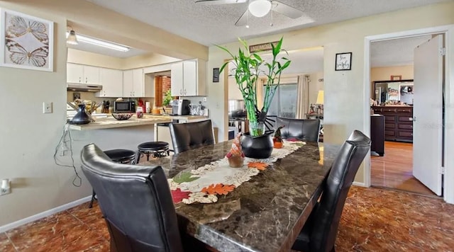 dining room with ceiling fan and a textured ceiling