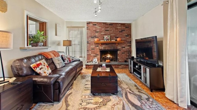 living room with a textured ceiling and a brick fireplace