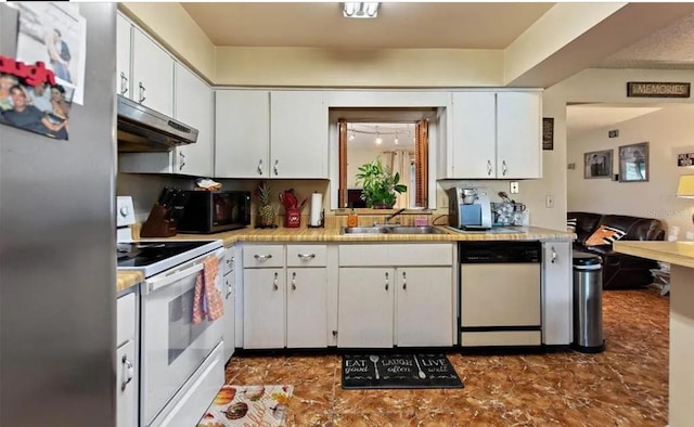 kitchen featuring white cabinetry, sink, and white appliances