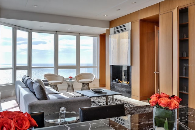 living room featuring a water view and a healthy amount of sunlight