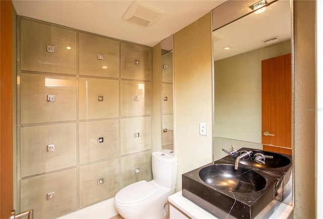 bathroom with vanity, mail boxes, and toilet