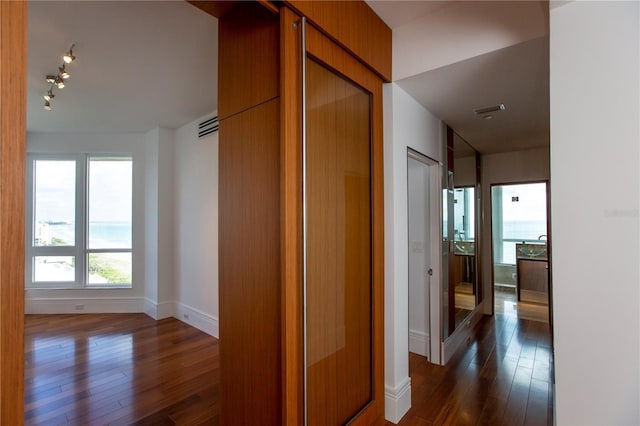 corridor featuring dark wood-type flooring