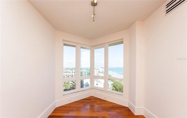 empty room with hardwood / wood-style flooring