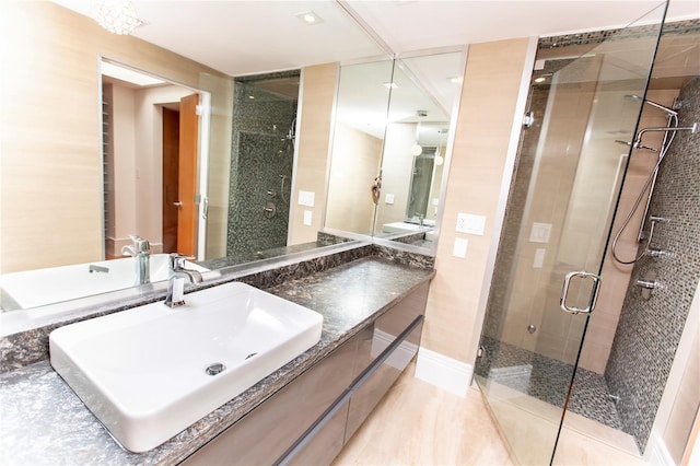 bathroom with tile patterned floors, a shower with door, and vanity