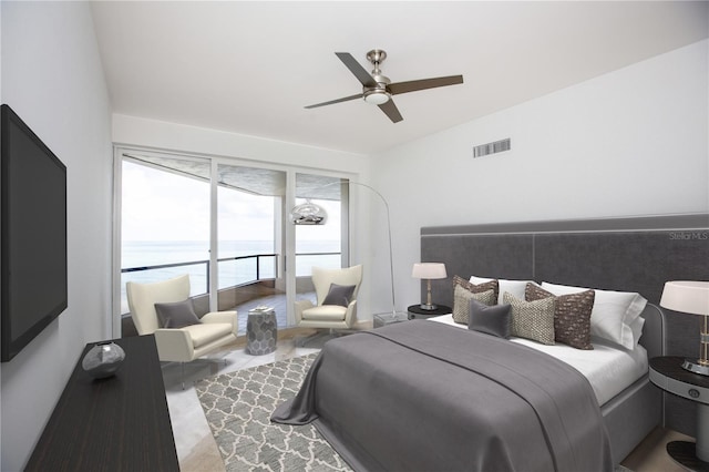 bedroom featuring a water view and ceiling fan