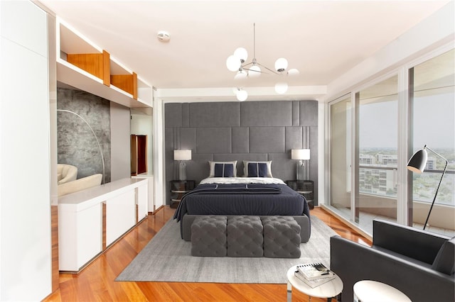 bedroom featuring light hardwood / wood-style flooring and a chandelier