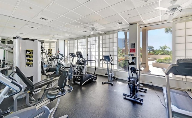 workout area featuring a paneled ceiling and ceiling fan