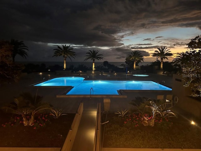 view of pool at dusk