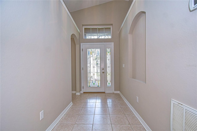 foyer featuring light tile patterned floors and a high ceiling