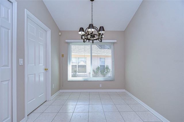 unfurnished dining area with light tile patterned floors and a notable chandelier