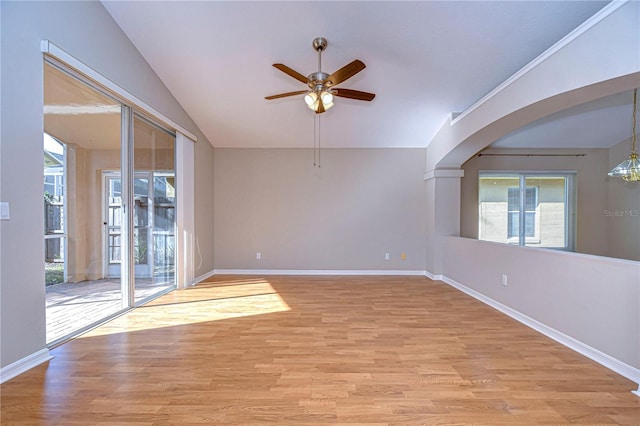 unfurnished room with ceiling fan, lofted ceiling, and light wood-type flooring